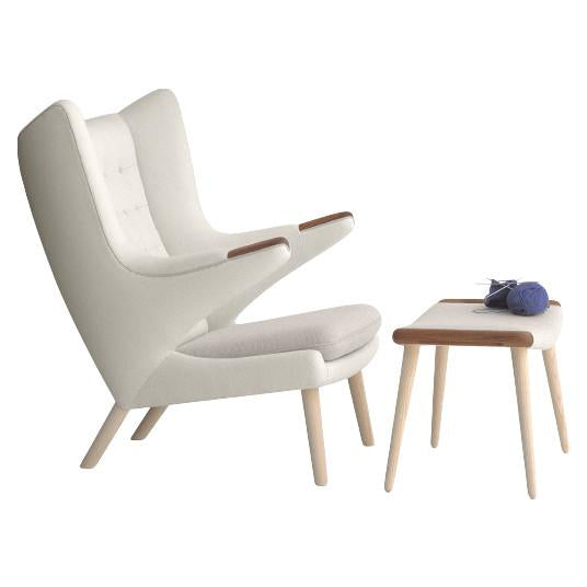 Modern cream armchair with light wood legs and a matching side table. Sleek, minimalist design and soft textures.