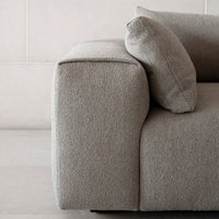 Gray textured sofa with a modern design, featuring a soft, cozy fabric and clean lines.