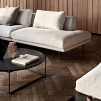 Light gray sectional sofa with textured fabric and minimalist design, paired with a sleek black coffee table.