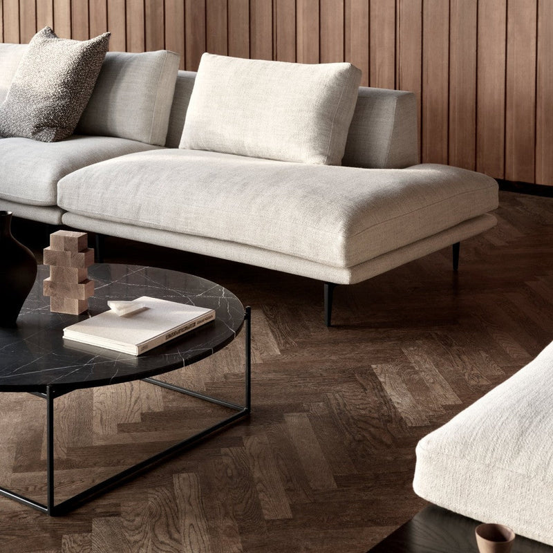 Light gray sectional sofa with textured fabric and minimalist design, paired with a sleek black coffee table.