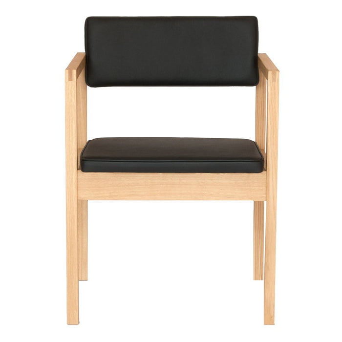 Black faux leather seat and backrest with natural wood frame, minimalist design, modern aesthetic.