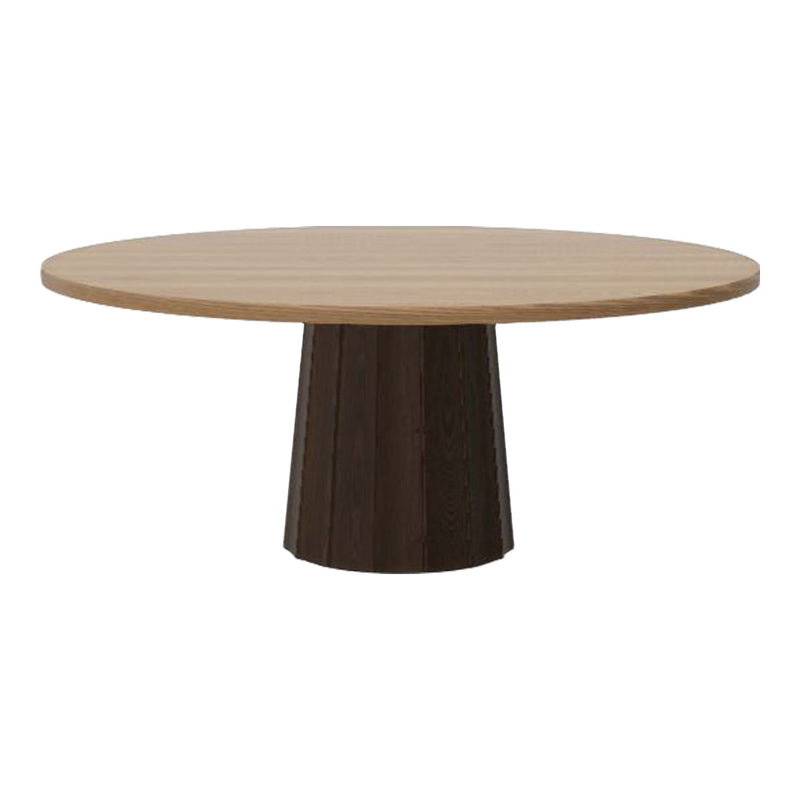 Round wooden dining table with a light oak top and a dark wood pedestal base, showcasing a sleek, modern design.