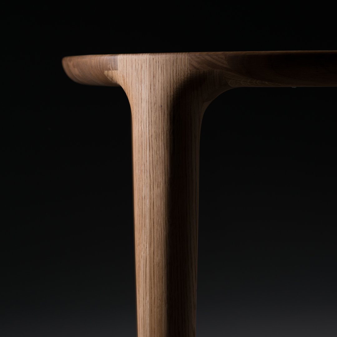 Natural wood grain with a warm, light brown finish and smooth edges against a black background.