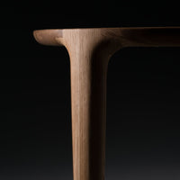 Natural wood grain with a warm, light brown finish and smooth edges against a black background.