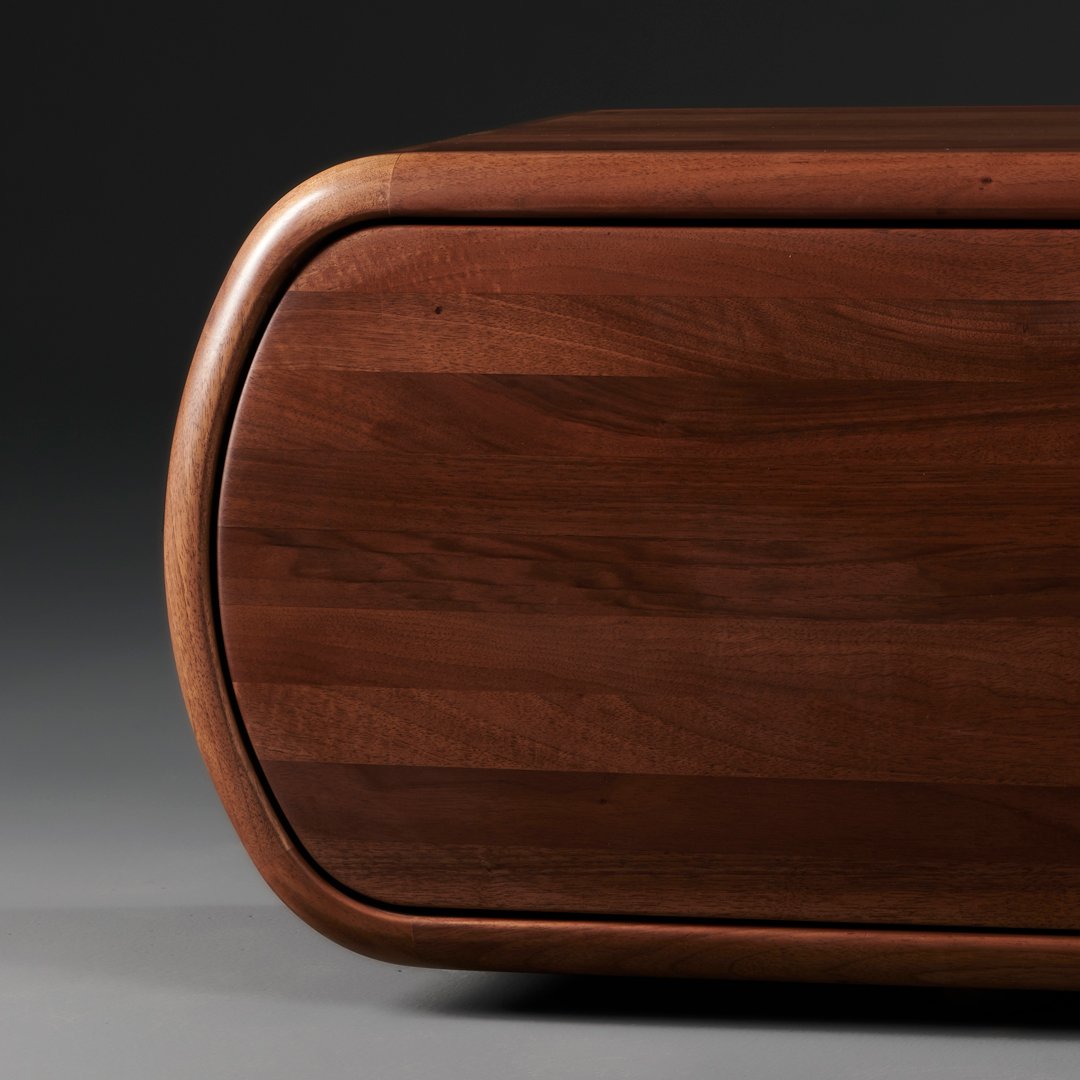 Rich walnut wood texture with smooth curves and a natural grain pattern, offering a warm, elegant finish.