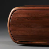 Rich walnut wood texture with smooth curves and a natural grain pattern, offering a warm, elegant finish.
