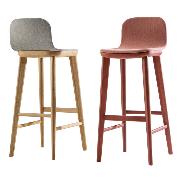 Two modern bar stools: one in light grey fabric with a natural wood base, the other in rust fabric with a darker wood base.
