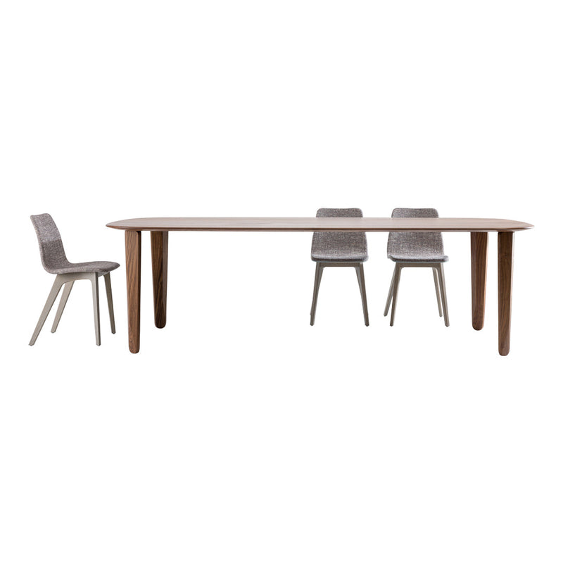 Modern wooden dining table in light oak finish with sleek gray chairs featuring minimalist design and subtle textures.